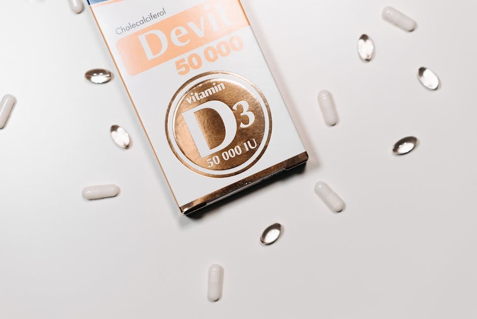 Flat lay of Vitamin D supplement box and capsules on a light background.
